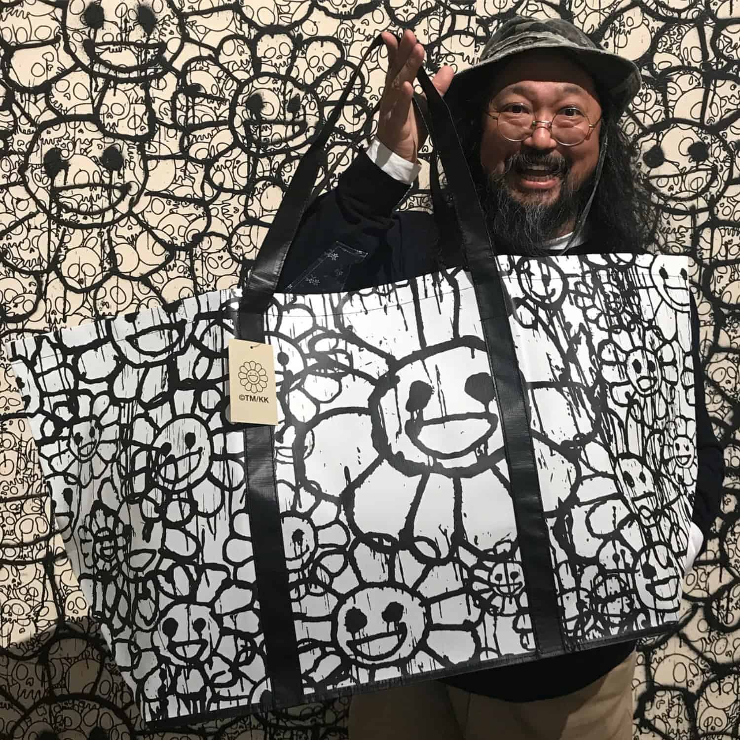 Bright floral tote bag featuring Murakami's signature smiling flower design.