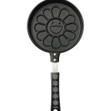 Pancake maker featuring Murakami's iconic flower design with a smiling face, black handle, and flowe.
