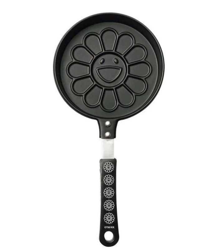 Takashi Murakami Flowers Pancake Maker Black Handle Pancake maker featuring Murakami's iconic flower design with a smiling face, black handle, and flowe.