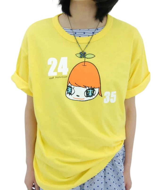 Bright yellow T-shirt featuring a cartoon character with a large orange head and Japanese text, insp.