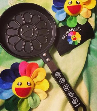 Flowers pancake maker by Takashi Murakami with black handle, inspired by colorful flower designs.