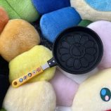Bright yellow pancake mold with flower design and colorful handle, perfect for creative breakfast pr.