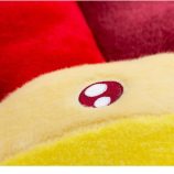 Cushion pillow inspired by Takashi Murakami's iconic flower design, featuring vibrant red and yellow.
