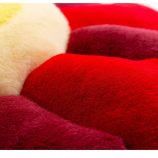 Colorful plush flower cushion pillow inspired by Takashi Murakami's art, vibrant red and yellow tone.