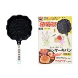 Pancake maker featuring Takashi Murakami's flower design with yellow handle, perfect for creative br.