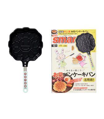 Pancake maker featuring Takashi Murakami's flower design with yellow handle, perfect for creative br.