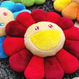 Cushion plush inspired by Takashi Murakami's iconic flower design, featuring vibrant colors and soft.