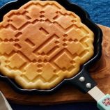 Pixel Flower pancake maker with blue handle inspired by Takashi Murakami's art.