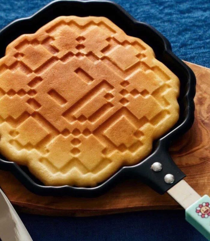 Pixel Flower pancake maker with blue handle inspired by Takashi Murakami's art.