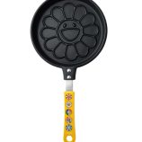 Pancake maker with flower design and yellow handle, inspired by Takashi Murakami's art, perfect for.