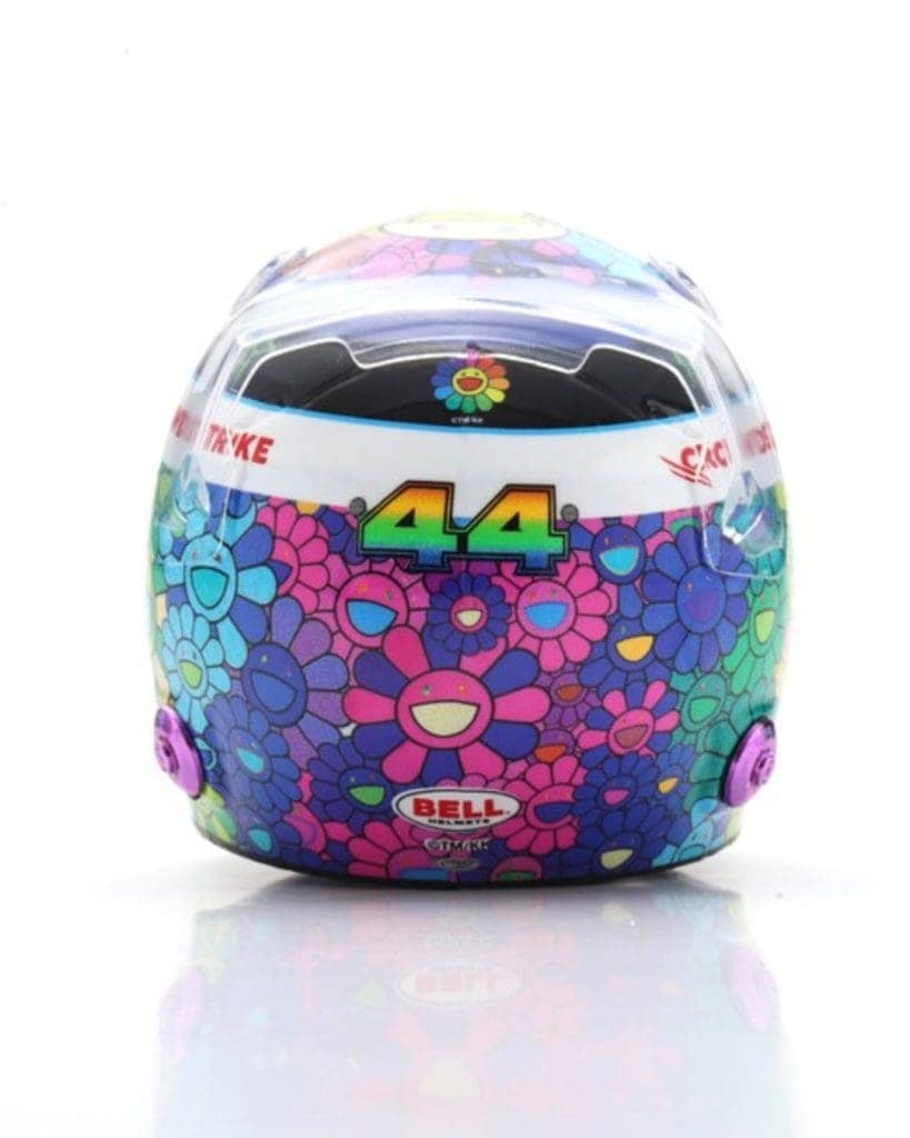 Miniature helmet inspired by Lewis Hamilton and Takashi Murakami collaboration, featuring vibrant fl.
