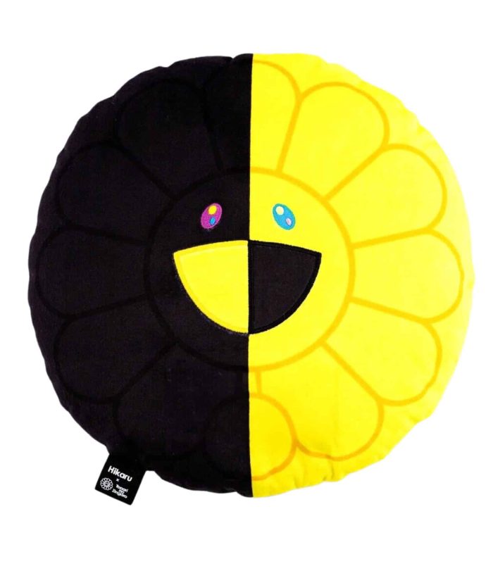 Bright yellow and black plush pillow with a cheerful smiley face design.