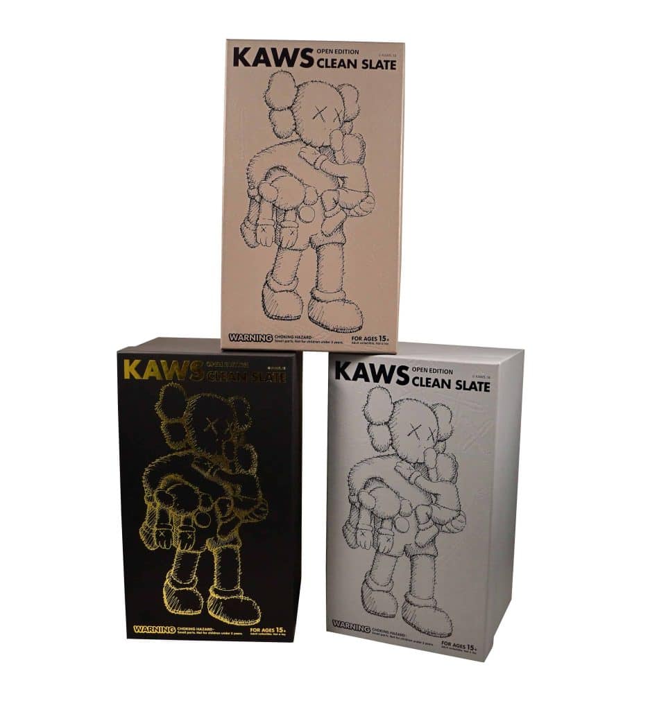 KAWS Clean Slate collectible figures in three color variants on display.