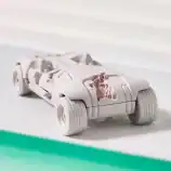 White futuristic toy car with damaged body parts, detailed design, on a neutral background.