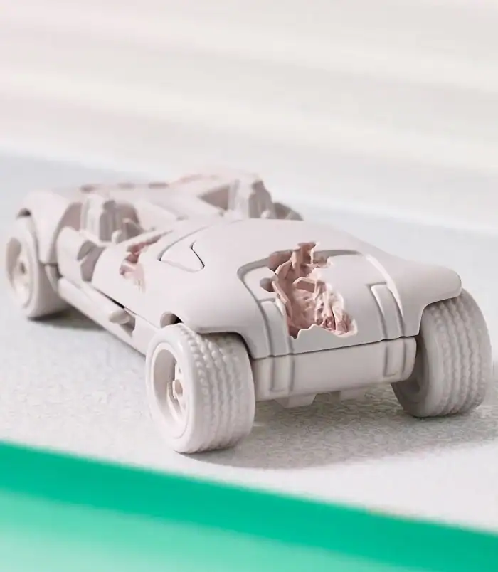Futuristic Toy Car Model White futuristic toy car with damaged body parts, detailed design, on a neutral background.