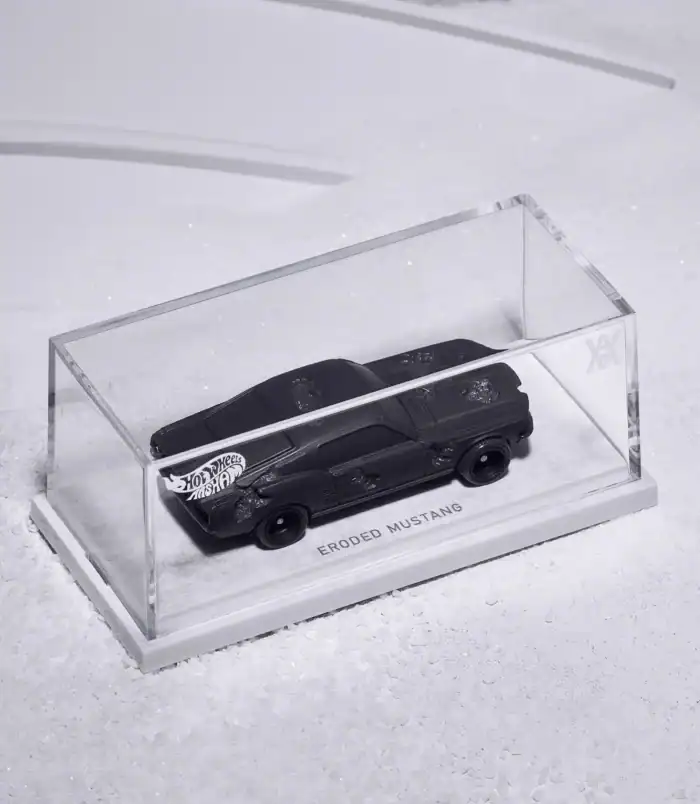 Eroded Mustang Hot Wheels collectible car in display case Black Hot Wheels Eroded Mustang in clear display case on snow.