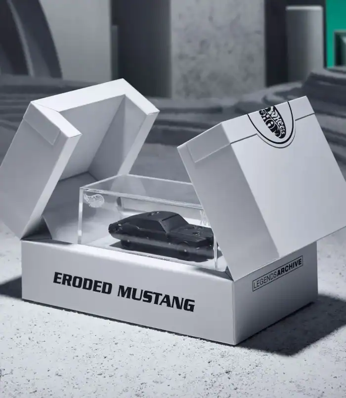 Eroded Mustang Collectible Car in Display Box Eroded Mustang model car in clear display box on concrete surface.