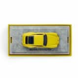 Yellow Porsche RS4 model car on display in a box.